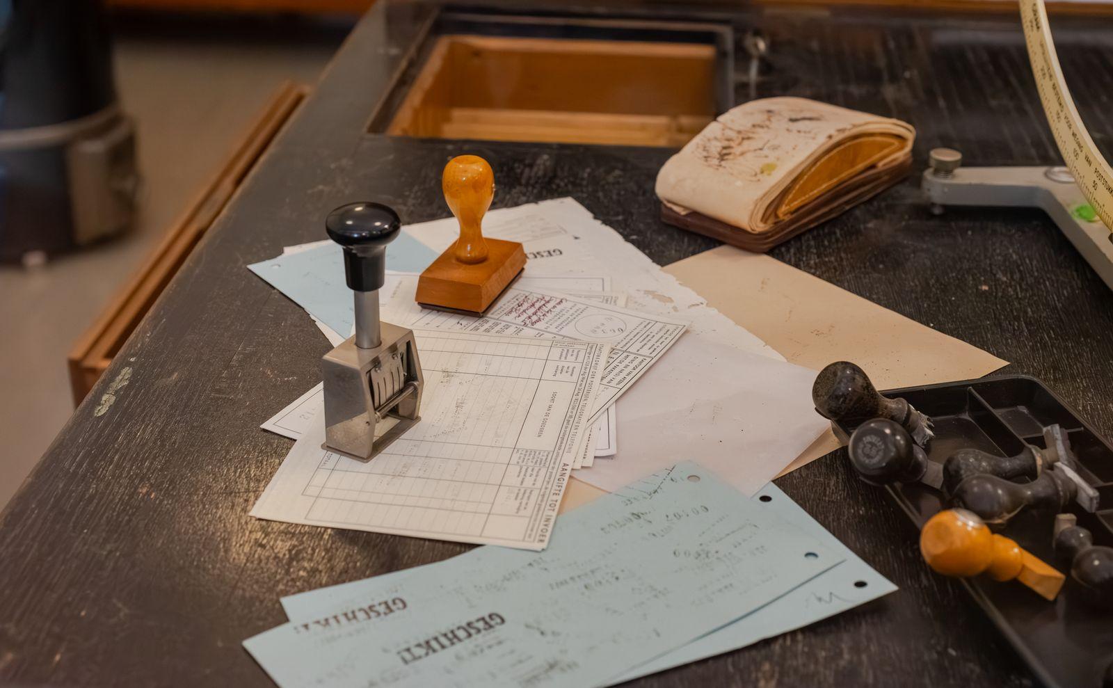 Certified document translations organized on a translator's desk with official stamps